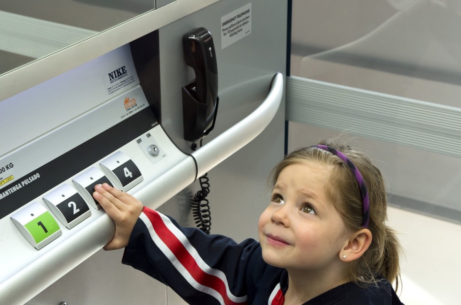 youg girl using Cibes Lift pressing on button in a school